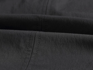 Close-up of black textile fabric with durable double-stitched parallel seams
