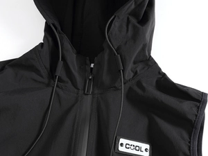 Close-up of black hooded vest featuring zip closure and COOL decorative chest patch
