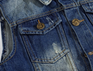 Detailed macro view of retro washed blue denim vest with contrast stitching and metal button