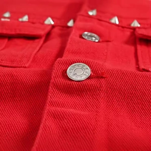 Men's red denim vest with metallic spikes and jeans buttons in rock punk style