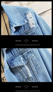 Detailed macro view of distressed shoulder and washed blue denim texture on jacket