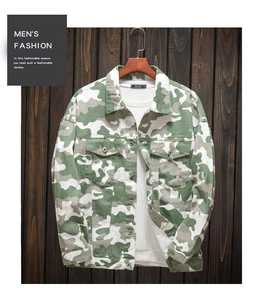 Detail of military camouflage jacket with metal buttons and classic chest pockets