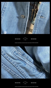 Detailed close-up of vintage embossed metal buttons and stitching on light blue denim jacket