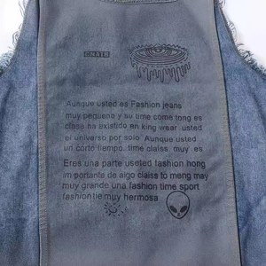 Back view of men's blue denim vest with patch, eye graphic, and distressed frayed edges