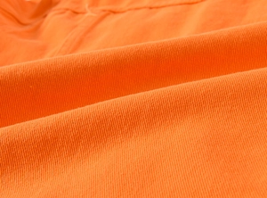 Nahaufnahme der hellorangen Denim-Stofftextur mit weichem Baumwollmischgewebe-Detail