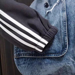 Men's denim jacket with knitted patchwork sleeves and distressed details in streetwear style