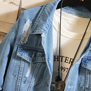 Men's light blue distressed denim jacket with vintage wash and front flap pockets