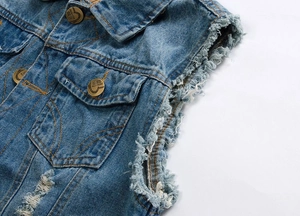 Detail view of men's distressed blue denim vest showing ripped edges and metal buttons