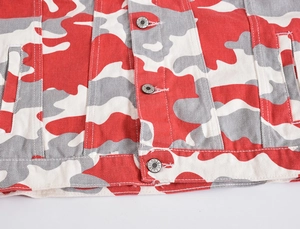 Detailed close-up of red camo denim jacket featuring engraved metal buttons and side pockets