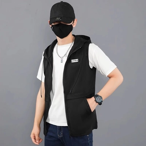 Close-up of black hooded vest with metal zipper and COOL creative woven patch detail