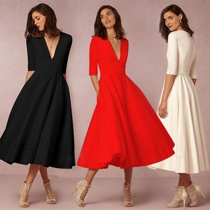 Detailed view of the deep V-neck and high waistline of this elegant flared dress