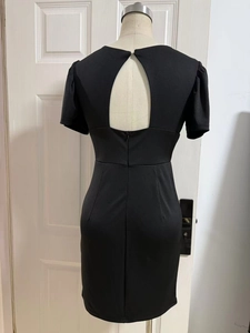 Detail view of the black bodycon dress featuring a teardrop cutout back design
