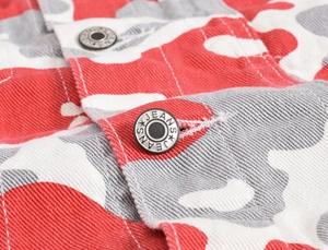 Close-up of red camo denim jacket with silver metal buttons and twill fabric texture