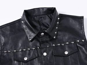 Close-up of black leather vest with silver metal spikes on the collar and chest pockets