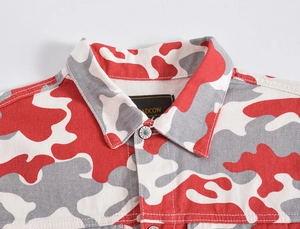 Detailed close-up of red camo denim jacket featuring metal jeans buttons and collar label