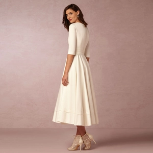 Detailed back view of an elegant cream mid-length dress with half sleeves and A-line skirt