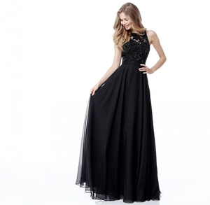 Close-up of elegant floral lace embroidery and sheer bodice on a black chiffon gown