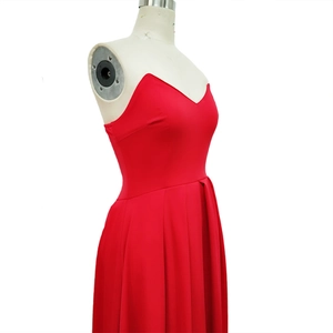 Detailed view of the red strapless cocktail dress with pleated skirt on a mannequin