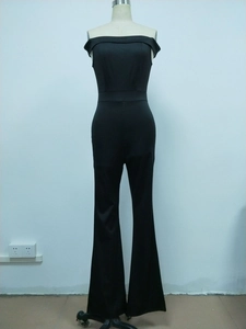Detail of off-shoulder black sleeveless jumpsuit with slim waist and flared leg on a mannequin