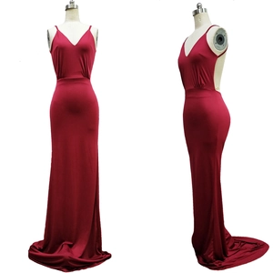 Detail of burgundy backless evening gown with sleek slim fit and elegant floor-length hem