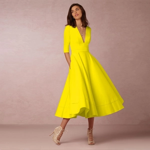 Detail of elegant bright yellow V-neck maxi dress with stylish mid-length flared skirt