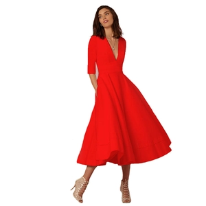 Detail of red V-neck dress featuring mid-length sleeves and flared A-line skirt