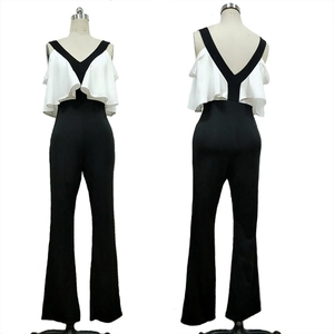 Detail view of monochrome contrast jumpsuit with ruffled sleeves and flared trousers
