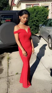 Detail of red off-shoulder mermaid evening dress showing V-neckline and slim fit silhouette