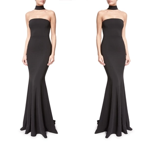 Elegant black mermaid evening gown with halter neck accessory and sleek floor-length cut