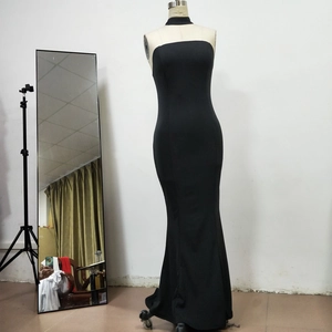 Detail of elegant black fishtail dress with halter neck on a professional mannequin