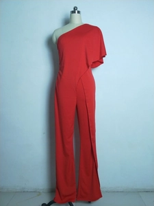 Detail view of red one-shoulder jumpsuit featuring elegant draped sleeve and wide leg design
