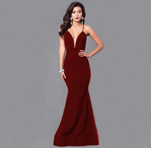 Detailed view of the deep red mermaid evening gown with thin straps and a plunging V-neckline
