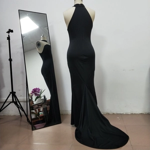 Detailed back view of a black halter neck mermaid evening dress with an open back design