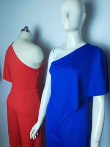Detail view of red and blue one shoulder jumpsuits with elegant asymmetric drape sleeves