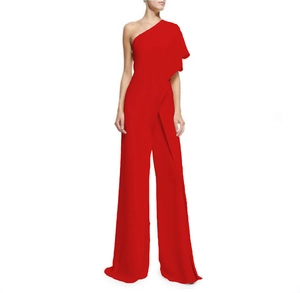 Detail of red one-shoulder jumpsuit featuring elegant ruffle sleeve and wide-leg trousers