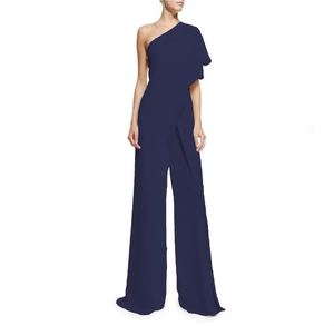 Detail of navy blue one-shoulder jumpsuit featuring ruffled sleeves and wide-leg cut