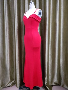 Detail of red off-shoulder mermaid evening dress with thin straps on mannequin