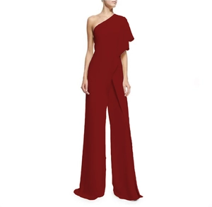 Close-up of elegant burgundy one-shoulder jumpsuit with layered ruffle shoulder details