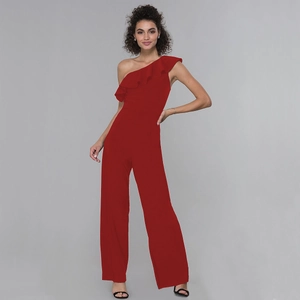 Detailed close-up of dark red one-shoulder ruffle design on an elegant wide-leg jumpsuit