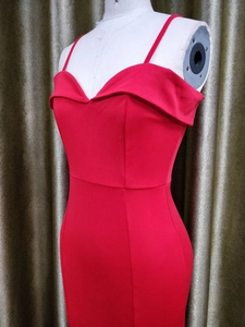 Detail of red off-shoulder evening dress with slim fit cut and narrow shoulder straps