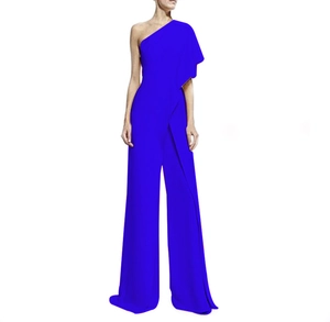 Close-up of royal blue one-shoulder jumpsuit with draped sleeve and wide leg design