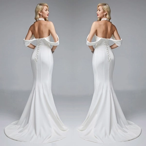 Detail of white mermaid evening dress featuring an elegant corset lace-up back and long train