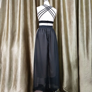 Detail view of back cross straps and sheer chiffon overlay on the long black evening gown