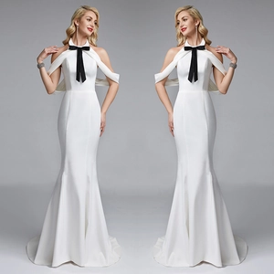 Elegant white mermaid evening gown with halter neck and black bow decoration