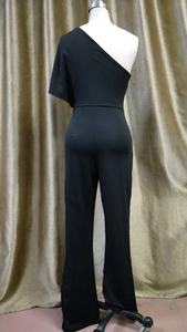 Detail view of the sleek black one-shoulder jumpsuit with wide leg pants and high waist
