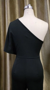 Detail view of black one-shoulder jumpsuit with asymmetric cut and invisible back zipper