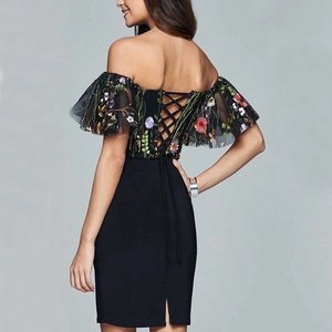 Detail of floral embroidery on mesh and lace-up back design of black off-shoulder dress