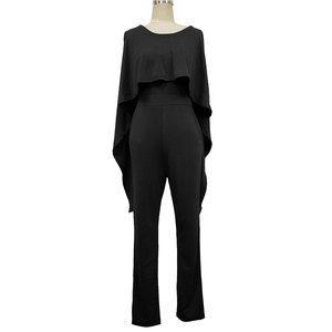 Detail of elegant black jumpsuit with large ruffle cape overlay and slim straight pants