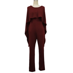 Detail of burgundy cape-style jumpsuit showing the elegant shawl neckline and slim fit design