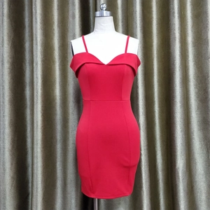Detail of red bodycon cocktail dress showing the sleek spaghetti straps and V-neckline fold